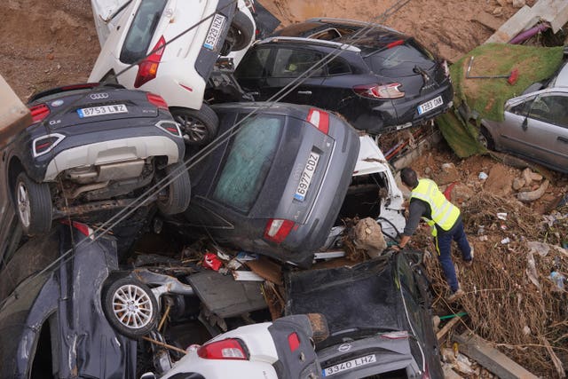 A civil guard searches for survivors in cars