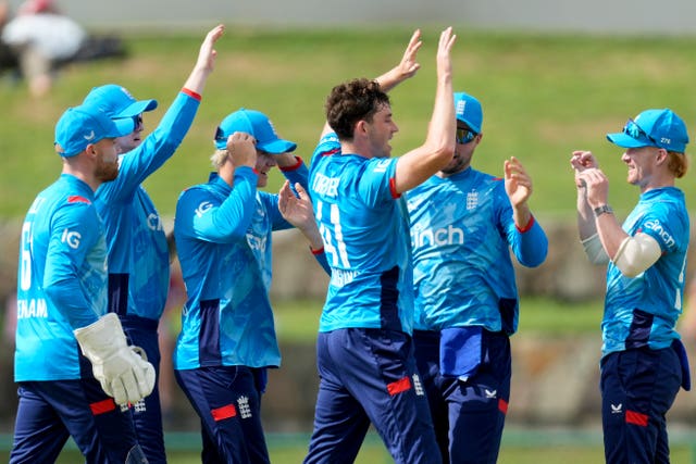 England’s John Turner, centre, celebrates taking the wicket of West Indies’ Brandon King (Ricardo Malazan/AP)