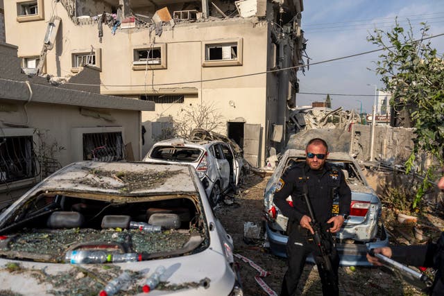 Damaged cars and a destroyed building 