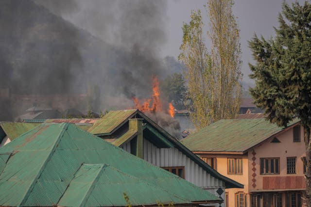 Flames billow from a residential building where militants are suspected to have taken refuge during a gun battle in Srinagar