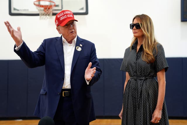 Republican presidential nominee Donald Trump speaks as former first lady Melania Trump listens after they voted on Election Day at the Morton and Barbara Mandel Recreation Centre in Palm Beach, Florida