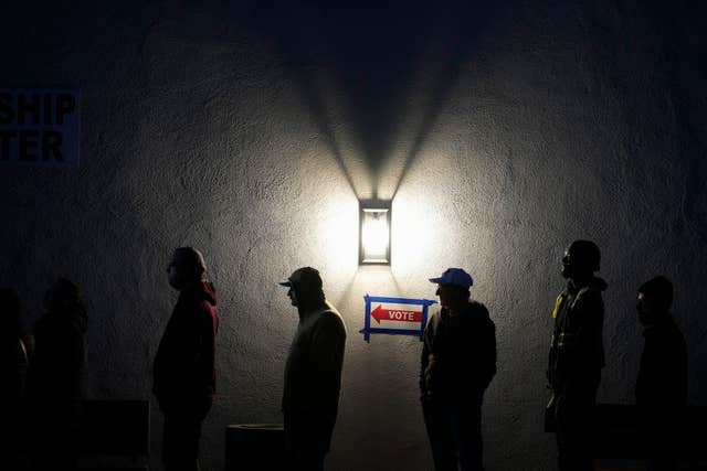 Voters stand in line outside a polling place at Madison Church in Phoenix, Arizona