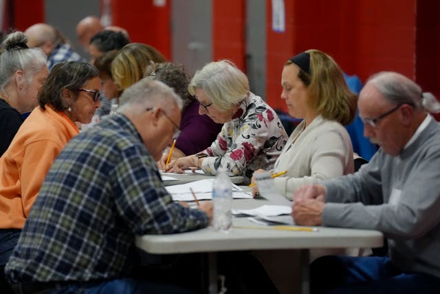 Poll workers count votes at a polling station in Derry, New Hampshire