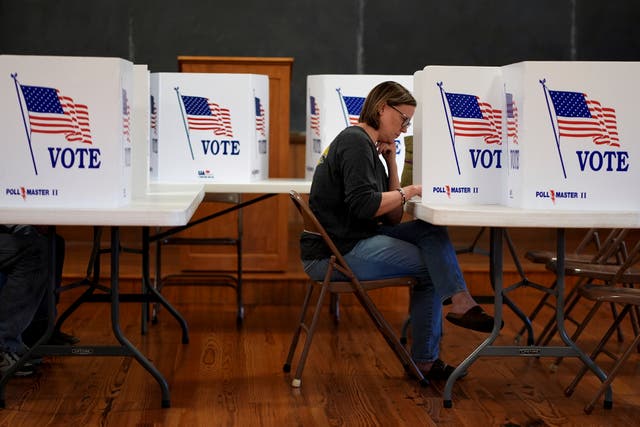 Kristin Scruggs votes at the 146-year-old Buck Creek School on Election Day in rural Perry, Kansas