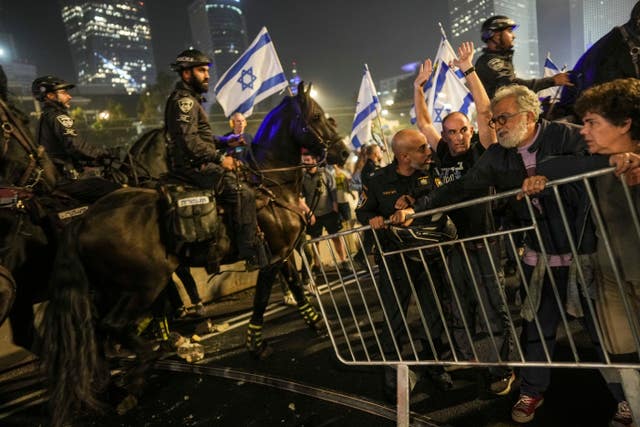 Israeli police try to push back protesters from a main road in Tel Aviv after Prime Minister Benjamin Netanyahu dismissed his defence minister Yoav Gallant in a surprise announcement 