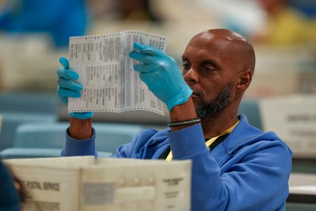 An election worker processing postal votes at the Philadelphia Election Warehouse