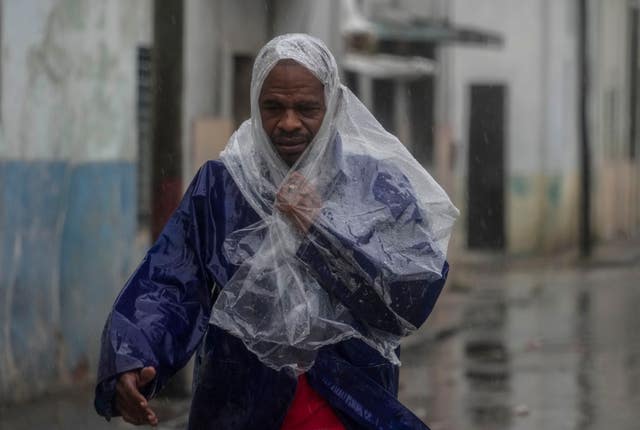 A man walks through the wind and rain 