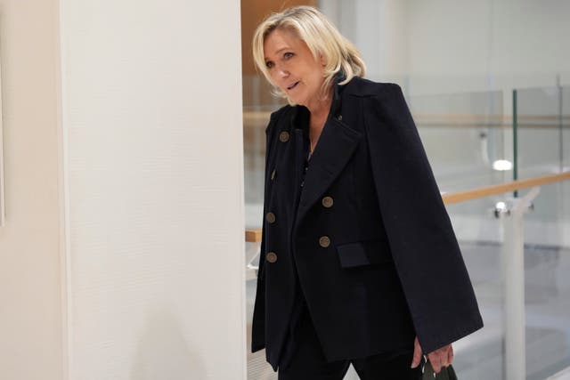 Marine Le Pen outside court in a black outfit