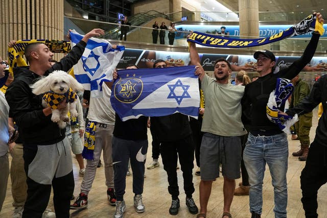 Maccabi Tel Aviv fans arrive at Israel’s Ben-Gurion International Airport (Tsafrir Abayov/AP)