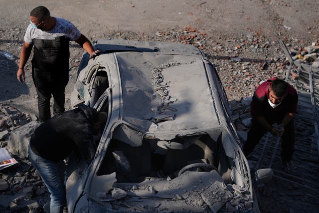 People check a damaged car