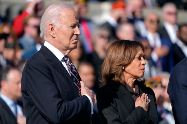 Joe Biden and Kamala Harris place their hands over their hearts