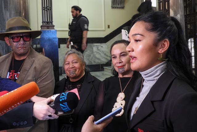 Hana-Rawhiti Maipi-Clarke, right, and her colleagues from Te Pati Maori, talk to reporters following a protest inside parliament in Wellington, New Zealand 