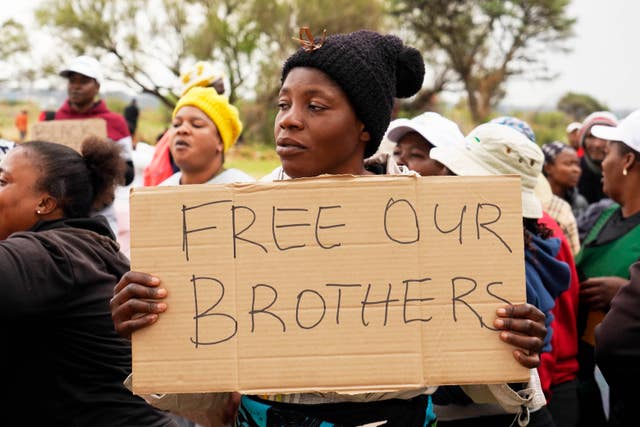 Relatives and friends protest near the mineshaft