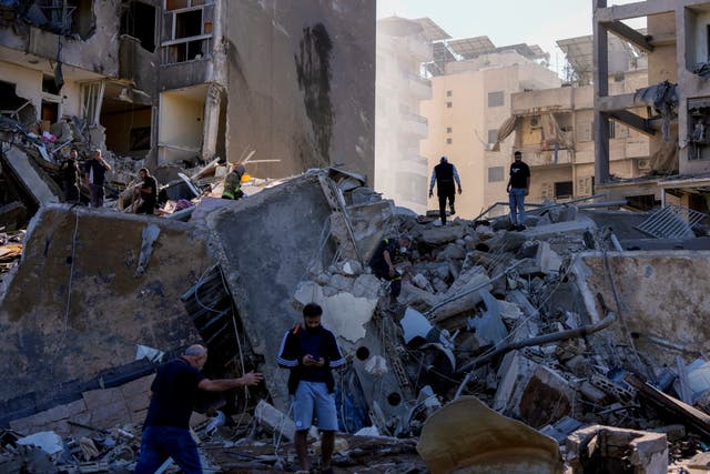 Residents check the site of an Israeli air strike in Tayouneh, Beirut, Lebanon