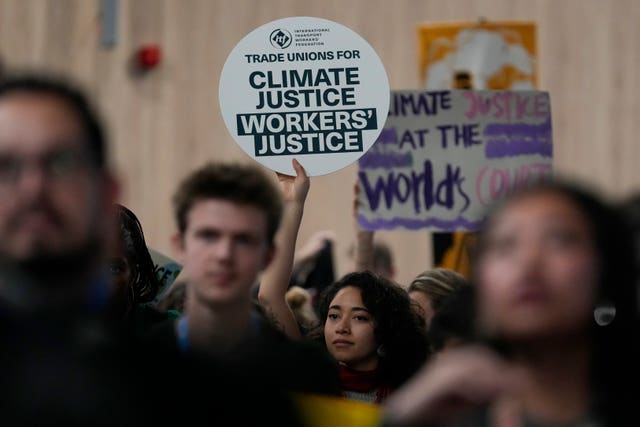 Activists with placards participate in a demonstration for climate justice