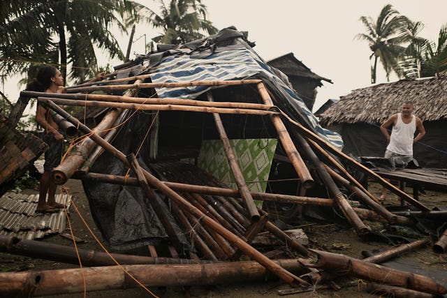 A resident checks his home that was damaged by Typhoon Man-yi in the municipality of Baler, Aurora province, northeastern Philippines