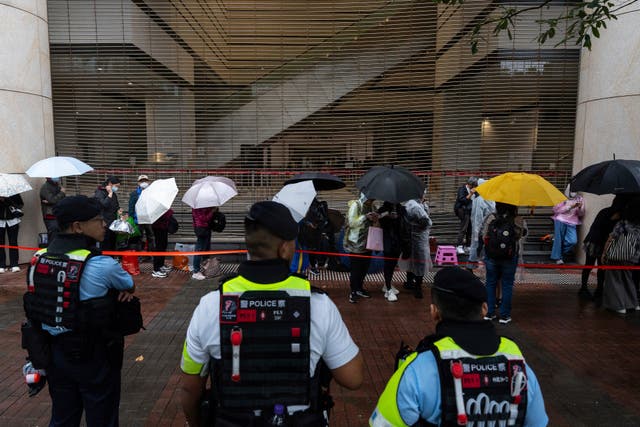 People wait outside the court in Hong Kong 