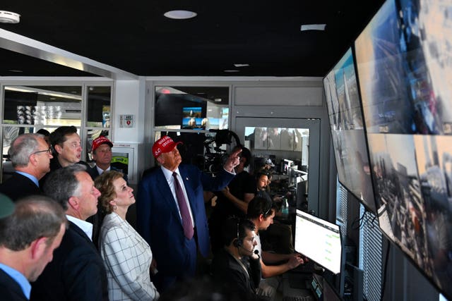 President-elect Donald Trump listens as Elon Musk explains the operations in the control room ahead of the launch 