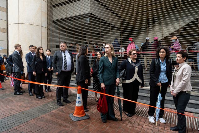 Representatives from different consulates wait in line outside the court in Hong Kong ahead of the sentencing 