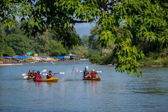 People kayaking on a river in Vang Vieng, Laos 