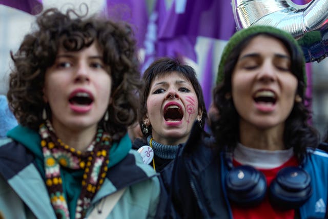 Women chant slogans during a rally marking the upcoming International Day for the Elimination of Violence Against Women,