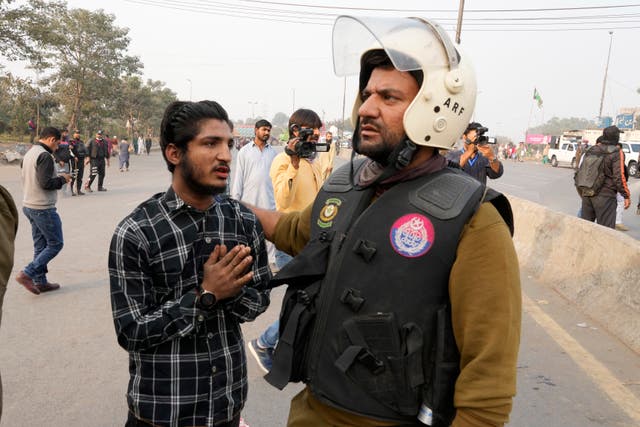 A police officer detains a supporter of imprisoned former premier Imran Khan’s Pakistan Tehreek-e-Insaf party,