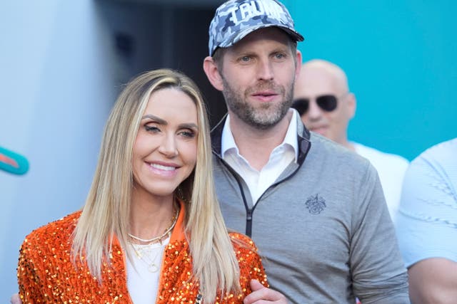 Eric and Lara Trump watch the second half of an NFL football game between the Miami Dolphins and the New England Patriots