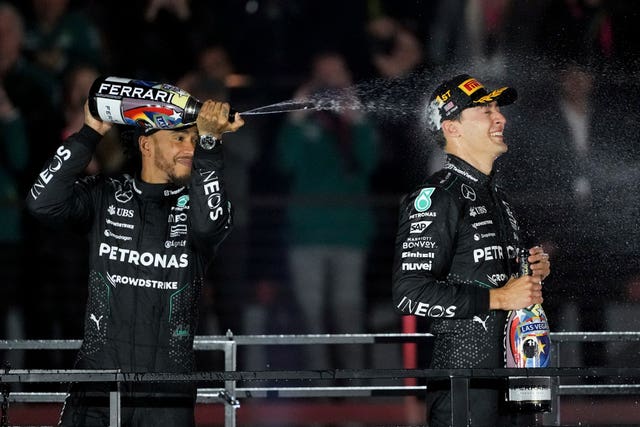 Lewis Hamilton sprays champagne on team-mate George Russell on the Las Vegas Grand Prix podium