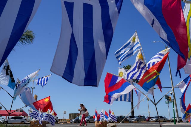 Flags flying against a blue sky