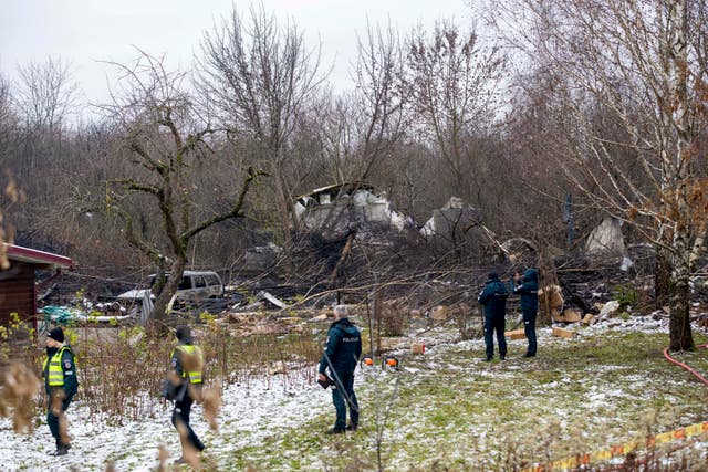 Workers at the site in a snowy forest scene