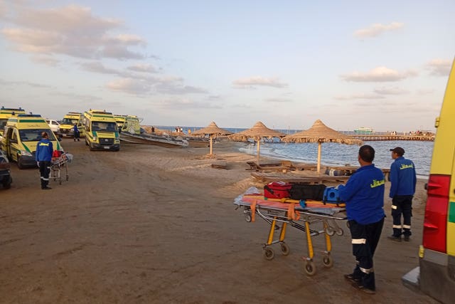 Rescuers wait on the beach of Marsa Alam, Egypt, after a tourist yacht sank in the Red Sea 