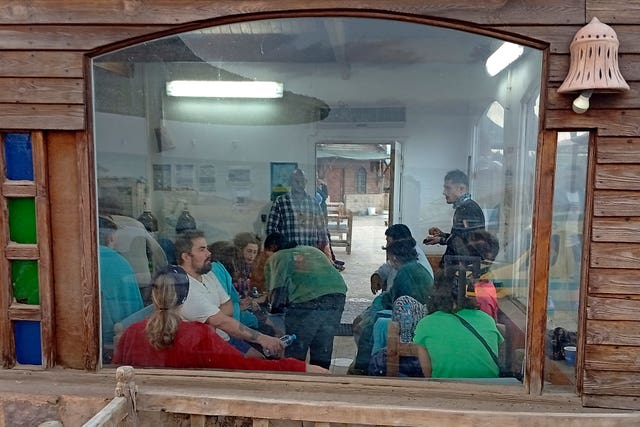 Survivors rest at a coffee shop in Marsa Alam