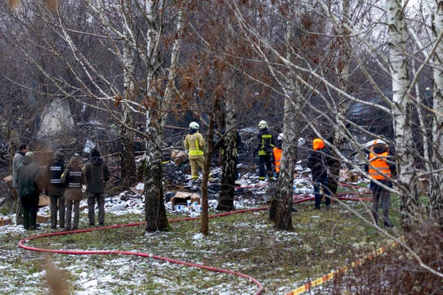 Lithuanian Emergency Ministry employees work at the site