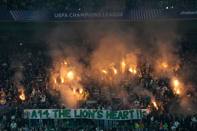 Sporting’s fans cheer for their team during the Champions League match against Arsenal