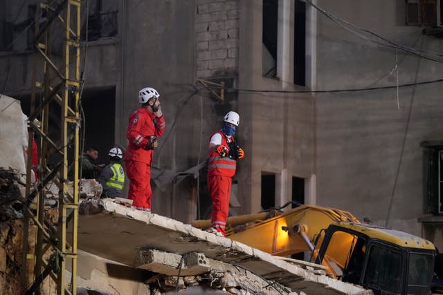 Rescuers search for victims at the site of an Israeli air strike in Beirut