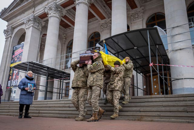 Fellow soldiers carry a coffin of leading actor Petro Velykiy, 48, who was killed in a battle with the Russian troops in Russia’s Kursk region, during farewell ceremony in the music and drama theatre in Chernyhiv, Ukraine