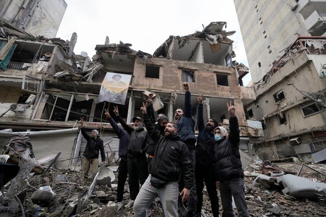 Hezbollah supporters cheer as they return to Dahiyeh, in Beirut