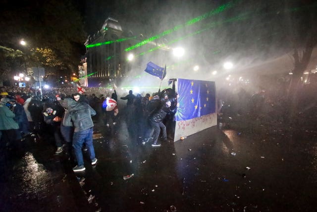 Protesters hold an EU flag during a rally outside the parliament building in Tbilisi, Georgia