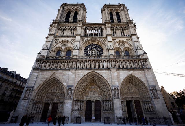 People stand outside Notre Dame Cathedral in Paris