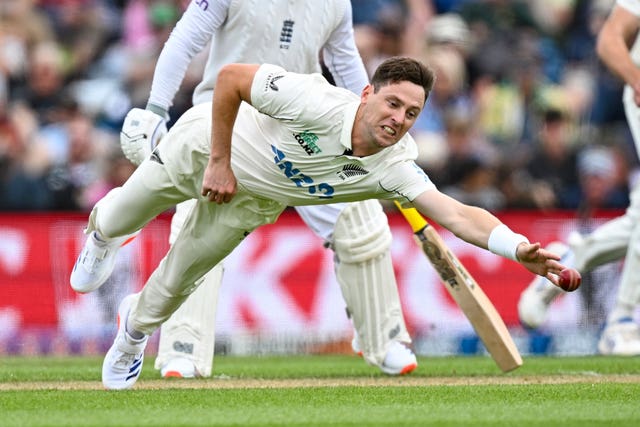 New Zealand’s Matt Henry dives