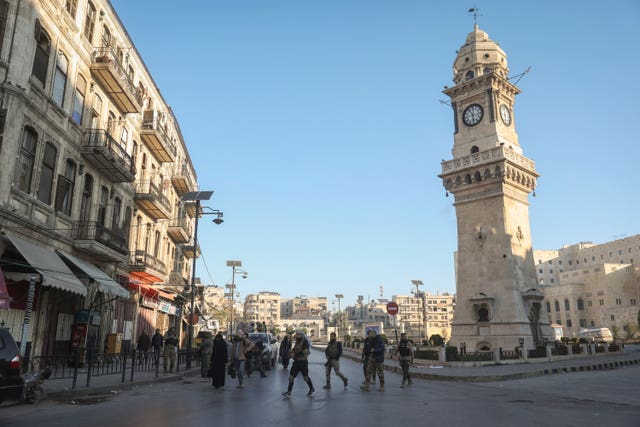 Syrian opposition fighters patrol the streets of Aleppo