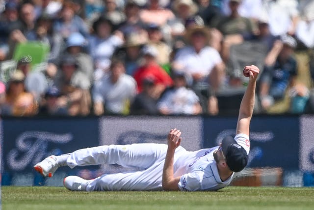 Gus Atkinson of England reacts after taking a catch to dismiss New Zealand’s Devon Conway