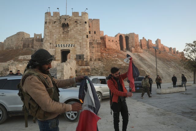 Syrian opposition fighters burn government Syrian flags