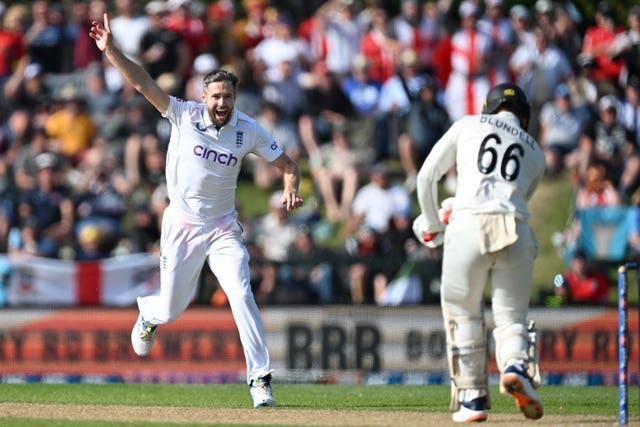 England bowler Chris Woakes runs down the wicket as he celebrates the dismissal of New Zealand batsman Tom Blundell