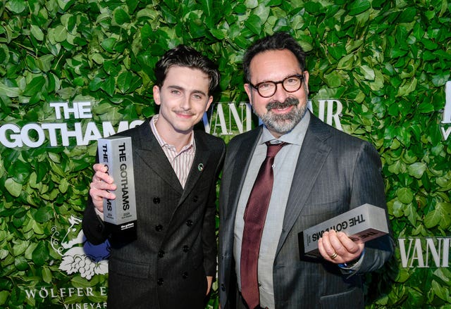 Timothee Chalamet, left, and James Mangold pose with the visionary tribute award for A Complete Unknown during The Gothams Film Awards