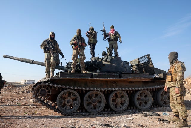 Syria Insurgency fighter stands on a tank