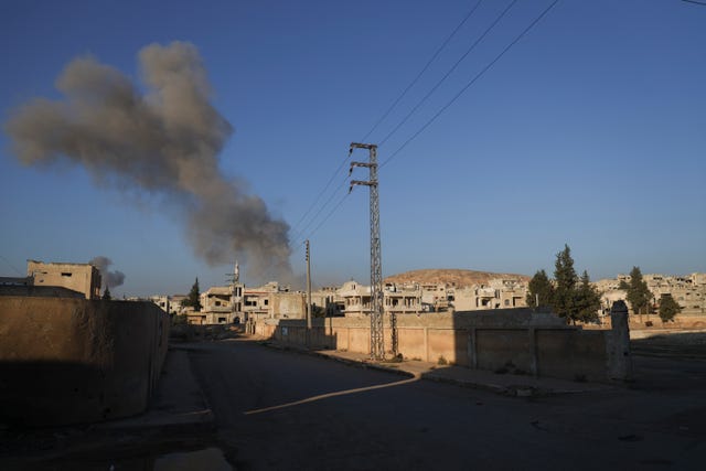 Smoke from an ai rstrike by government forces billows in the sky over the town of Khan Sheikhoun, south of Idlib