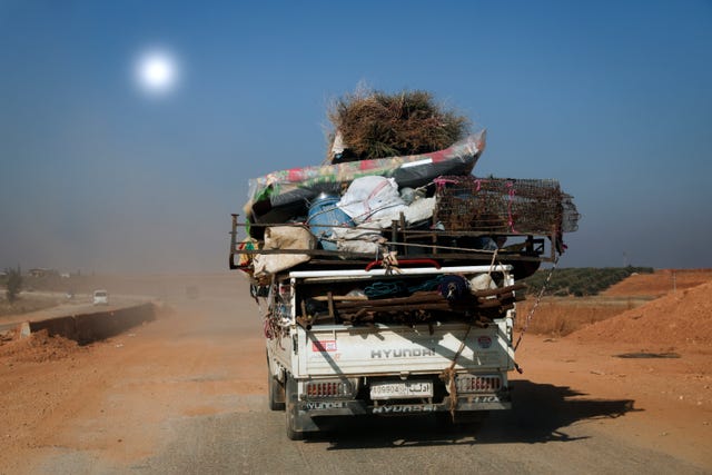 A jeep packed with people and their belongings