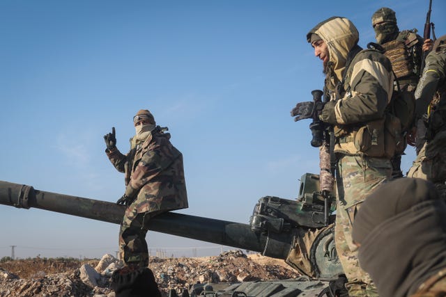 Syria Insurgency fighters on a tank