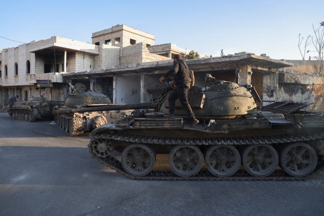 An armoured vehicle moves through streets